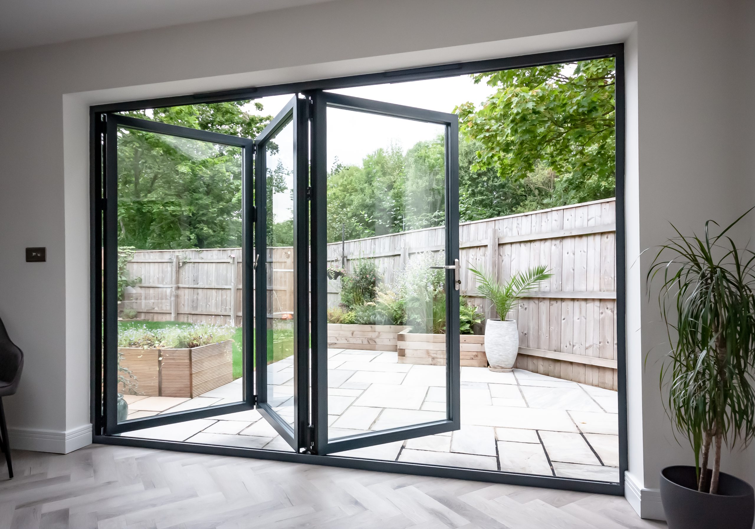 Opened Korniche aluminium bifold doors.