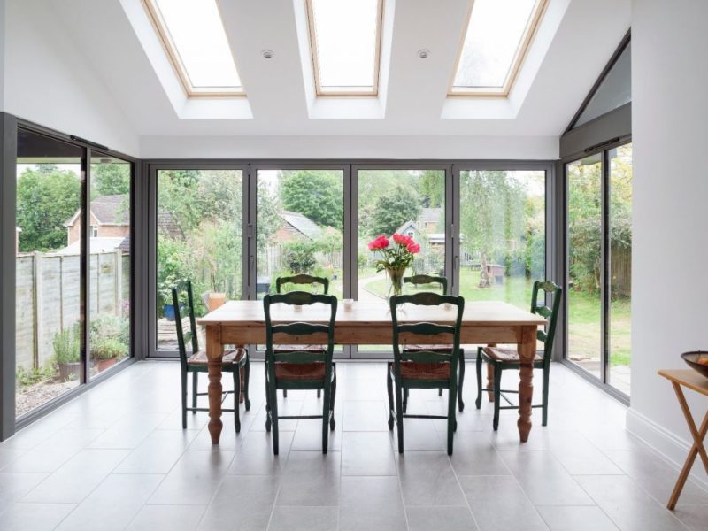A dining area with Korniche aluminum bifold doors.